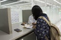 Asia traveler thai women writing departure card and arrival card at counter Royalty Free Stock Photo