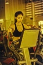 Asia woman doing exercise on elliptical trainer in fitness gym Royalty Free Stock Photo