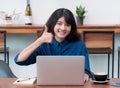 Asia woman freelancer thumbs up and smile using laptop with coffee cup in cafe restaurant,woman working outside office,digital li Royalty Free Stock Photo