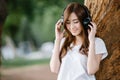 Asia woman listening music headphones outdoor Royalty Free Stock Photo