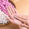 An Asia woman is making Tang yuan, yuan xiao, Chinese traditional food rice dumplings in red and white for lunar new year, winter Royalty Free Stock Photo