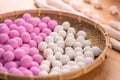 An Asia woman is making Tang yuan, yuan xiao, Chinese traditional food rice dumplings in red and white for lunar new year, winter Royalty Free Stock Photo