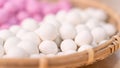 An Asia woman is making Tang yuan, yuan xiao, Chinese traditional food rice dumplings in red and white for lunar new year, winter Royalty Free Stock Photo