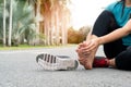 Asia woman massaging her painful foot while exercising. Running Sport and excercise injury concept Royalty Free Stock Photo