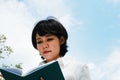 Asia woman reading and holding book on sky background Royalty Free Stock Photo