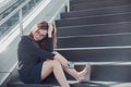 Asia woman stressed from work sitting on steps outside