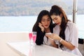 Asia woman traveling for relaxation and drinking wine on speed boat at Thailand. Royalty Free Stock Photo