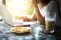 Asia woman Using Laptop In Coffee Shop