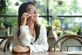 Asia woman using mobile phone for talking with someone on break