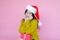 asia woman wearing long sleeve clothes on pink background with gift box in hand, Christmas or X\'mas and happy new year Royalty Free Stock Photo