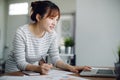 Asia woman working with laptop in living room