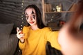 Asia women micro influencer with Halloween make-up record live video camera at home studio. girl youtuber fun talk speak