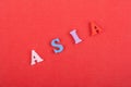 ASIA word on red background composed from colorful abc alphabet block wooden letters, copy space for ad text. Learning english Royalty Free Stock Photo