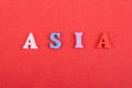 ASIA word on red background composed from colorful abc alphabet block wooden letters, copy space for ad text. Learning Royalty Free Stock Photo