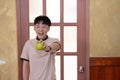 Asia young man with green apple in house door background Royalty Free Stock Photo