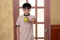 Asia young man with green apple in house door background Royalty Free Stock Photo