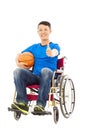 Asia young man sitting on a wheelchair and thumb up Royalty Free Stock Photo