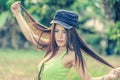 Asia young Woman wearing green vest on park