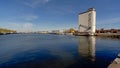 Large dock with ships in front of an abandoned industrial building in the harbor of Antwerp