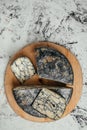 Asiago italian cheese with cuttlefishink on a wooden board. banner, menu, recipe place for text, top view Royalty Free Stock Photo