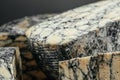 Asiago italian cheese with cuttlefishink on a wooden board. banner, menu, recipe place for text, top view Royalty Free Stock Photo