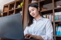 Asian accountant using calculator and computer notebook