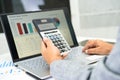 Asian accountant working and analyzing financial reports project accounting with chart graph and calculator in modern office, Royalty Free Stock Photo