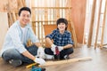 Asian adorable Father and son helped to do woodwork at home