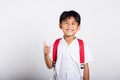 Asian adorable toddler smiling happy wearing student thai uniform red pants show thumb up finger Royalty Free Stock Photo