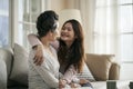 Asian adult daughter and senior mother chatting at home Royalty Free Stock Photo