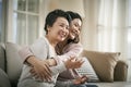 Asian adult daughter and senior mother hugging each other at home Royalty Free Stock Photo