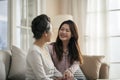 Asian adult daughter and senior mother enjoying conversation at home Royalty Free Stock Photo