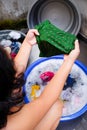 Asian Adult Woman Looking for Some Stain on Cllothes During Laundry