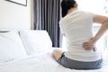 Asian adult woman suffering from backache,tightness in shoulder,neck ache,symptom of chronic muscle pain or office syndrome, Royalty Free Stock Photo