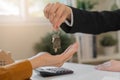 Asian agent giving a key to new owner or tenant, client after signed signature contract rental purchase, buyer apartment, home Royalty Free Stock Photo