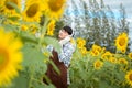 Asian agriculture is resting in the sunflower field. Happy after work Royalty Free Stock Photo