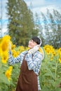 Asian agriculture is resting in the sunflower field. Happy after work Royalty Free Stock Photo