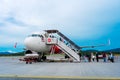 A322 Asian airline passenger plane boarding passengers stairway. At the airport on the island of Langkawi Royalty Free Stock Photo