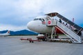 A322 Asian airline passenger plane boarding passengers stairway. At the airport on the island of Langkawi Royalty Free Stock Photo