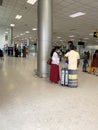 Asian airlines passengers with luggage waiting for check-in through airport building, aircraft flights on electronic scoreboard, Royalty Free Stock Photo