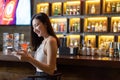 Asian alone women enjoy cocktails in front of a vintage bar, Relaxing activities after work or hangouts