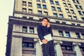 Young Asian American college student talking on cell phone outside office building in New York City Royalty Free Stock Photo