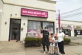 Asian American family outside their business, Long Island, New York, United States of America