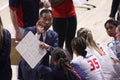 Asian American man coaching his volleyball team