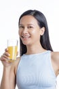 Asian American Woman drinking a glass of Orange Juice Royalty Free Stock Photo