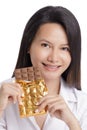 Asian American woman enjoying a Milk Chololate candy bar Royalty Free Stock Photo