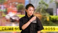 Asian American Woman Police Officer at Crime scene Royalty Free Stock Photo