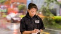 Asian American Police Officer at Crime scene Taking Notes Royalty Free Stock Photo