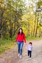 Asian appearance mother walking with her child in warm sunny autumn day