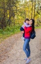 Asian appearance mother walking with her child in warm sunny autumn day